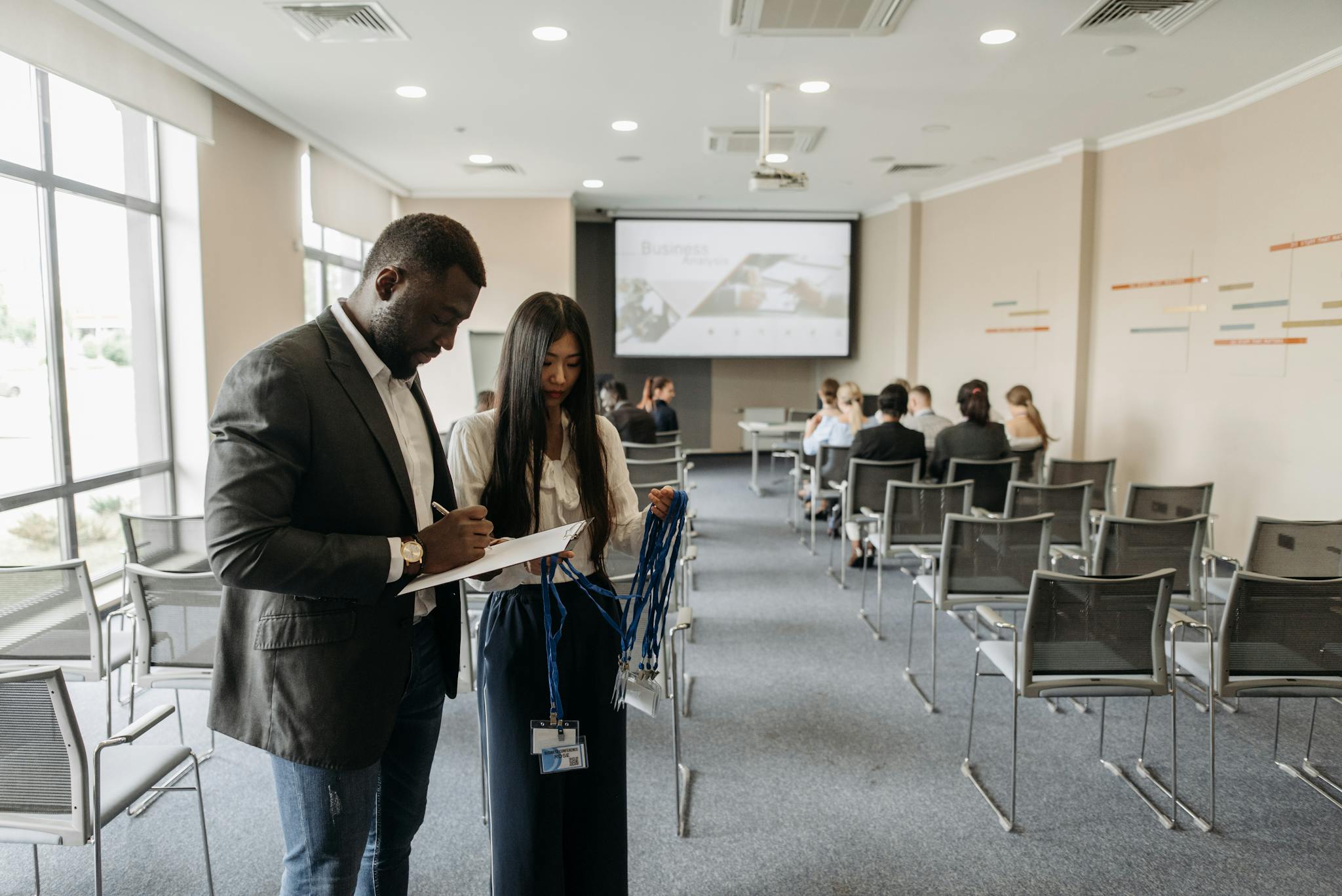 A diverse team prepares for a business conference in a modern office setting.